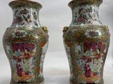 pair of chinese vases on a white surface with a white background