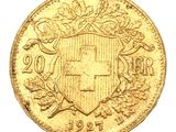 a close up of a gold coin with a coat of arms on it
