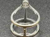 two silver rings with a diamond on top of them on a black surface