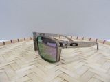 a pair of sunglasses sitting on top of a wicker basket