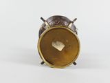 a close up of a small brass clock on a white surface