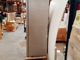 an image of a refrigerator in a warehouse with a lot of boxes