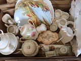 a box full of tea pots and tea cups and saucers