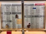 two rows of glasses on display in a store window
