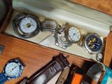many different watches in a box on a table