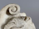 a statue of a man with a goat on his head