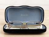 a pair of glasses sitting in a case on a table