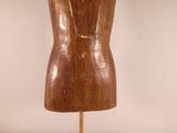 an image of a wooden mannequin on a metal stand