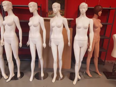 many mannequins that are lined up in a row