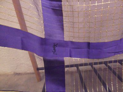 a close up of a chair with a purple ribbon on it