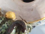 a frog figurine that is sitting on a table