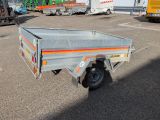 a small trailer that is parked in a parking lot