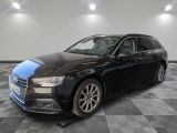 the black audi wagon is parked in a large room