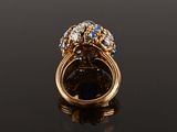 an 18k gold ring set with sapphires and diamonds
