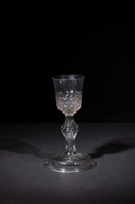 crystal goblet on a black table with a black background