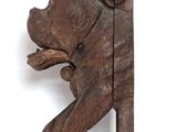 a wooden sculpture of a dog hanging on a wall
