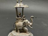 statue of a man riding an elephant with a man on top of it