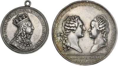 two silver medals of two women with crowns on them