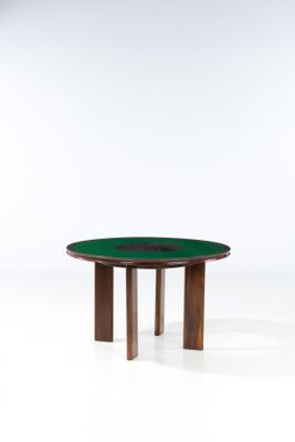 a round table with a wooden base and green glass top