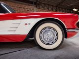 an image of a red and white car parked in a garage