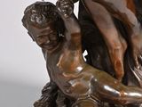 bronze statue of a man and a woman on a rock