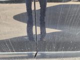 a reflection of a person in a car door