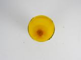 a small yellow object on a white surface