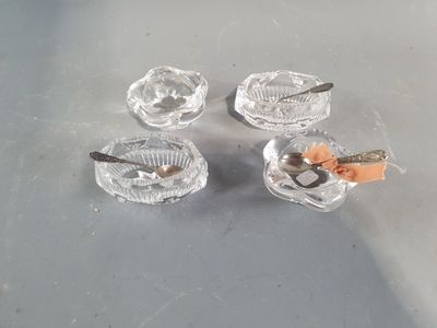 quatre petits cendriers en verre contenant chacun une cuillère