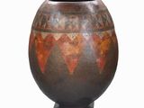 a vase that is sitting on a stand on a white background