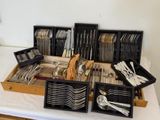 a lot of silverware in the trays on the table