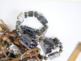 a pile of jewelry sitting on a table next to a comb