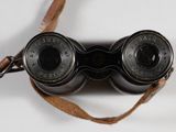 a pair of binoculars that are sitting on a strap