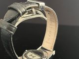 a watch that is sitting on a black table
