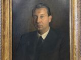 portrait of a man in a suit and tie in a gold frame