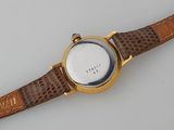 a watch that is sitting on a white surface