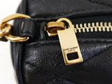 a close up of a black purse with a gold zipper