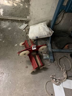 a toy airplane that is on the ground next to a bag
