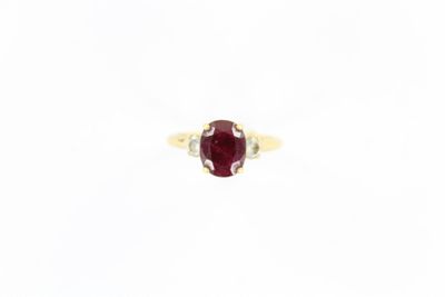 Gros plan sur une bague contenant une pierre rouge