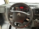 a steering wheel and dashboard of a car with a clock
