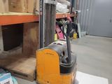 a forklift in a warehouse with boxes on the floor