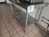 a microwave sitting on top of a stainless steel table