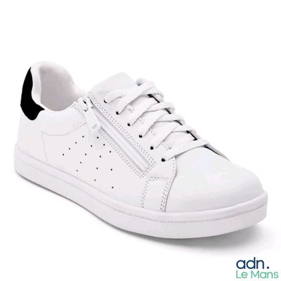 white and black sneakers with zippers on the side of them
