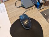 a computer mouse on a mouse pad on a desk