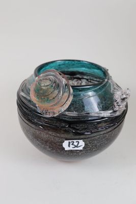 a glass jar with a lid on a white surface