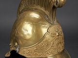 a gold helmet with a decorative design on the side