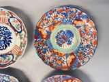 three plates with different designs on them on a white surface