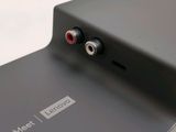 the back of a black phone with two red buttons on it