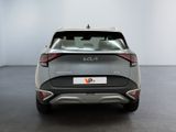 the rear end of a silver car in a white room