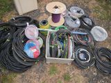 many different types of hoses and spools laid out on the ground