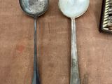 two spoons and a spoon rest on a table